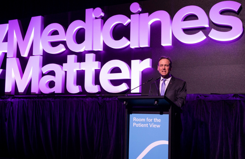 Minister Hunt stands in front of a sign that reads "#Medicines Matter"